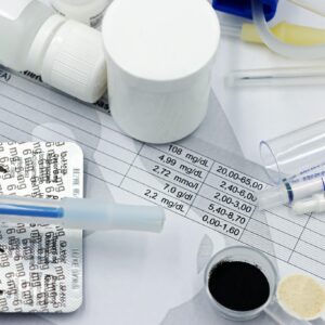 Vet supplies like syringes and medicines on blood test reports, suggesting medical care theme.